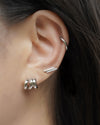 effortless and sophisticated ear stack featuring treble illusion huggie hoop, double bar ear stud and retractable hoop in silver from thehexad.com