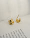 petite treble illusion huggie-style hoop earrings in gold by jewellery brand the hexad