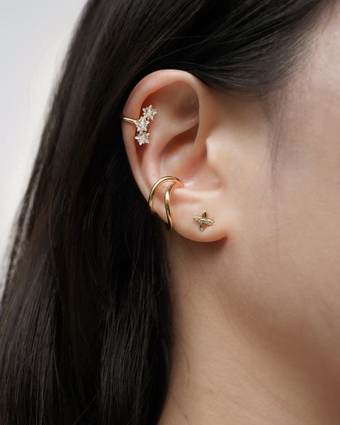 chic and trendy ear stack featuring conch ear cuff in gold