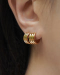 achieve this on-trend double lobe piercings look with the hexad's cleopatra hoop earrings in gold