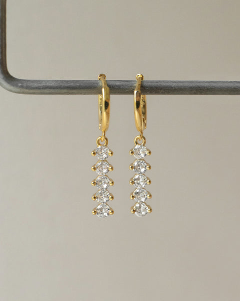 aurora dangle huggie hoop earrings in gold is your next party jewelry must have