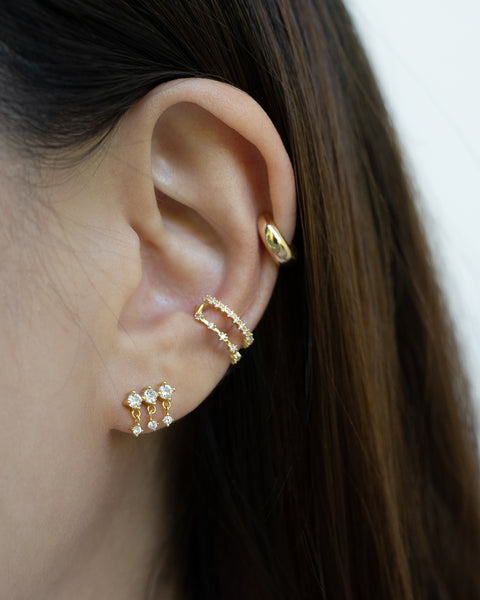 a winning golden ear stack combination featuring the new drizzle drop earrings and bestseller astraea conch ear cuff and cult ear cuff on the helix