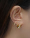 build your own unique ear stack with claudia twisted hoop and solaris teardrop earring in gold