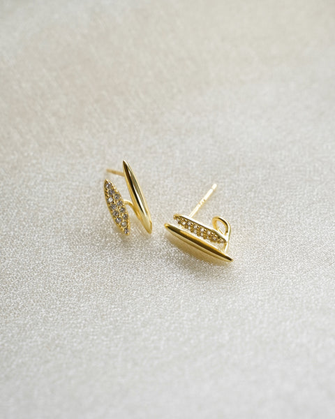 close up of petite oval shaped earrings with pretty pave diamonds from the hexad
