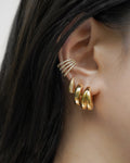 curate a dramatic multi ear piercings stack with diamond ear cuff and chunky gold hoop earrings from the hexad