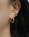 minimalist ear stack idea created with taylor tube hoop earring in silver and wave ear cuff from online shop the hexad