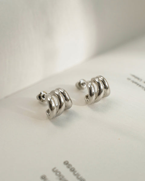 petite spherical hoop earrings in silver that hug the lobe comfortably