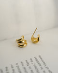 petite treble illusion huggie-style hoop earrings in gold by jewellery brand the hexad