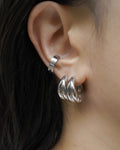 style-making ear stack featuring chunky bagel hoop earrings and bullet ear cuff in silver