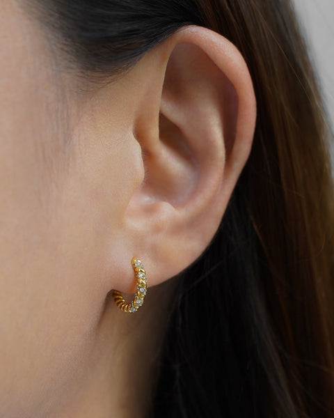 thick braided golden hoops finished with micro pave diamonds from the hexad