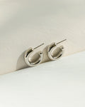 thick c-shape hoop earrings in silver from women's jewelry label the hexad