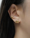 understated and minimalist ear stack curation featuring new arrival treble illusion huggie hoop and the best selling cult ear cuffs in gold by the hexad