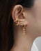 visually impactful ear stack idea from the hexad jewelry label featuring nova dangle earrings and mischief ear cuffs set