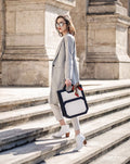Andreea Birsan of Couturezilla.com models The Hexad leather tote bag in white blazer suit