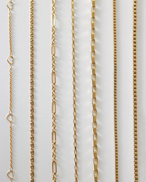 Assorted chain necklaces in gold from The Hexad's collection