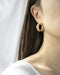 Distorted hoop earrings in gold plated metal - The Hexad