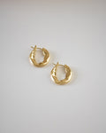 Flat golden hoops featuring a unique uneven surface @thehexad