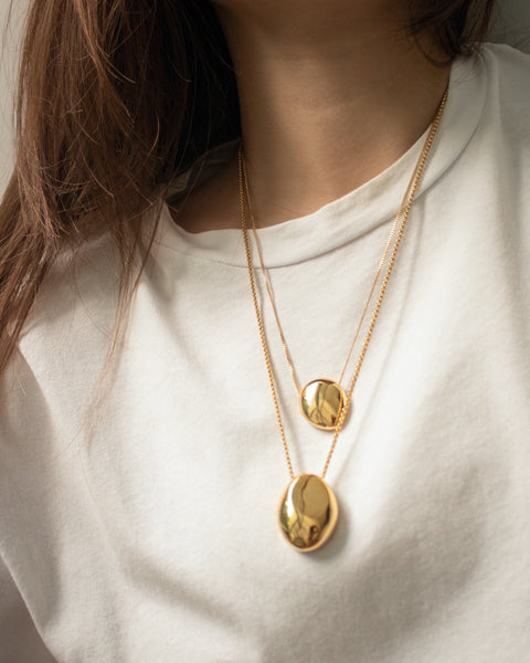Layer on statement sculptural pendants for maximum impact - Gaia and Pebble Necklace by The Hexad