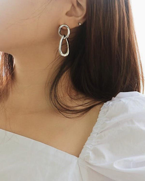 Minimal silver hoop drop earrings worn as a stud - The Hexad