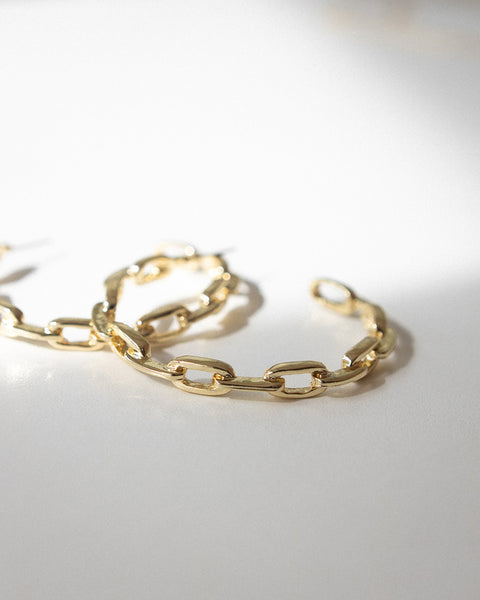 Modern golden hoop earrings for women designed by The Hexad