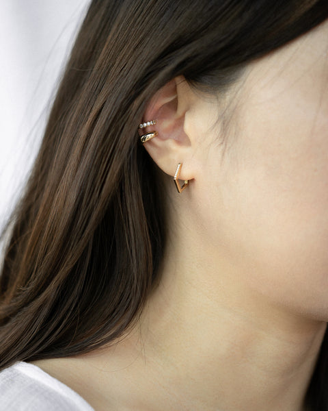 Modern hoop earrings in gold and embellished with rhinestones for a statement ear stack