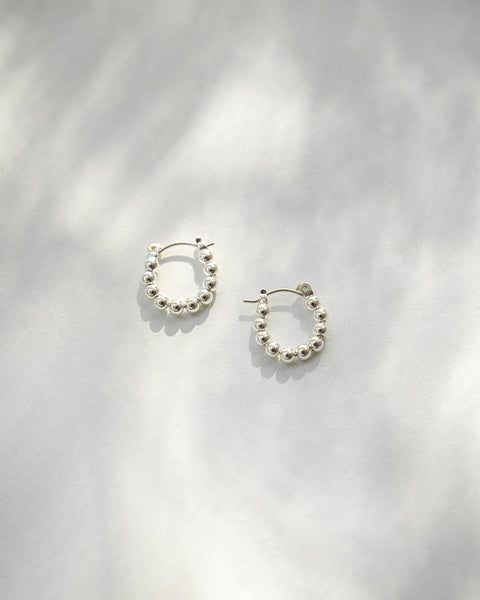 Modern silver hoop earrings with fun beaded detailing