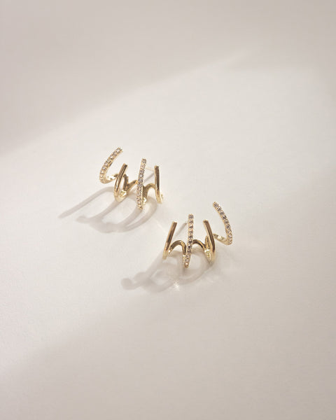 Modern illusion hoop earrings in gold by the hexad