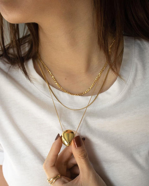 Pebble pendant, ellipses chain and reptile necklace by The Hexad