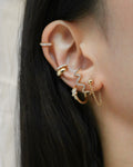 Serpent suspender earrings paired with huggies and ear cuffs - The Hexad