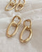 Simple interlocking hoop dangle earrings in gold - The Hexad