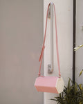 Small crossbody bag featuring a unique hexagon prism shape - fun and quirky styled bag - pink and white colors - The Hexad 