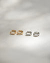 The Hexad rye huggie hoop earrings in gold and silver