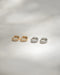 The Hexad rye huggie hoop earrings in gold and silver