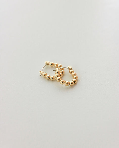 Tiny gold spheres earrings by The Hexad