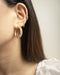 Wearing golden hoop earrings of multiple sizes on same ear - The Hexad