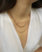 best selling rose gold chain necklaces from the hexad layered together to showcase a plunge neckline