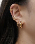 build your dream ear stack with classic gold hoops and statement diamond ear cuffs from the hexad