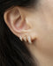 casual costume jewellery earrings styled in a stack along the lower ear lobe @thehexad