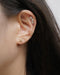 chic and trendy curated ear stack consisting nirvana star ear cuffs and fleur stud earring
