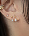 chic charm earrings layered with ear cuffs by jewelry label the hexad