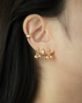 chic ear stack featuring tiny studs and ear cuffs by the hexad