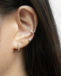 chic rye huggie hoop earrings layered with a simple diamond stud and moonshine ear cuff from the hexad