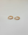 chic sorbet huggie earrings in rose gold with tiny diamonds by the hexad