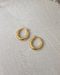 classic bold hoop earrings in gold from the rei of light collection by the hexad