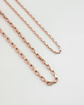 close up detailing of the parallel chain necklaces in rold gold hue from the hexad