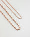 close up detailing of the parallel chain necklaces in rold gold hue from the hexad