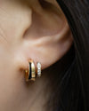 close up details of the latest atlantis illusion hoop earrings in gold designed by jewellery brand the hexad