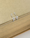 close up of elegant diamante design details in new arrival pixie huggie hoop earrings in silver