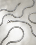 close up of silver herringbone chain necklaces designed by women's label the hexad