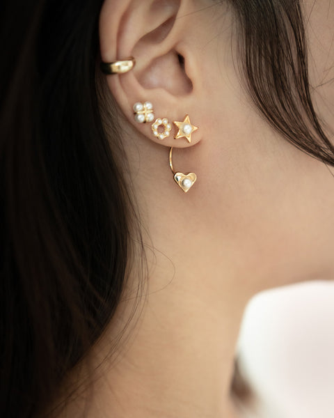 cult ear cuff layered with multiple stud earrings for dream stack inspiration